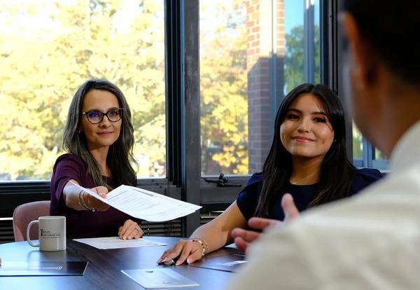 J Kelley Law Group team members meeting with a client during an immigration consultation.