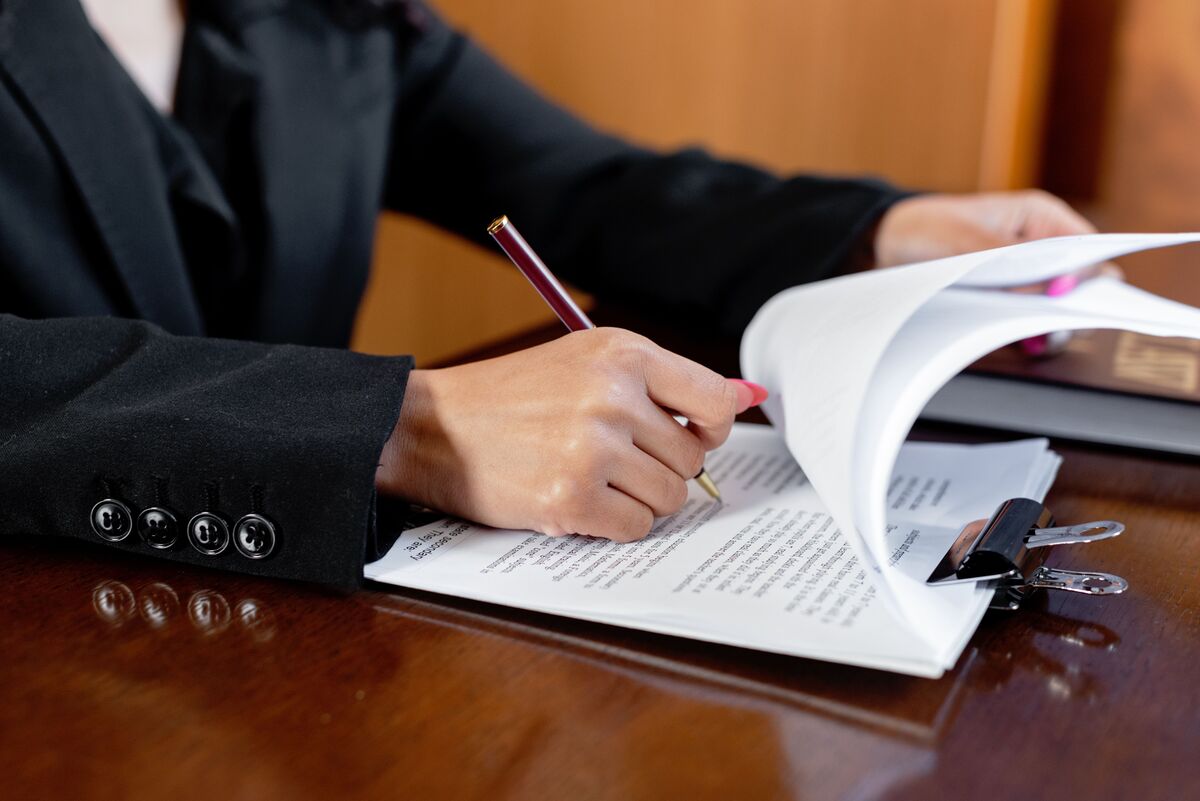 Attorney reviewing and signing legal documents as part of asylum application preparation with J Kelley Law Group