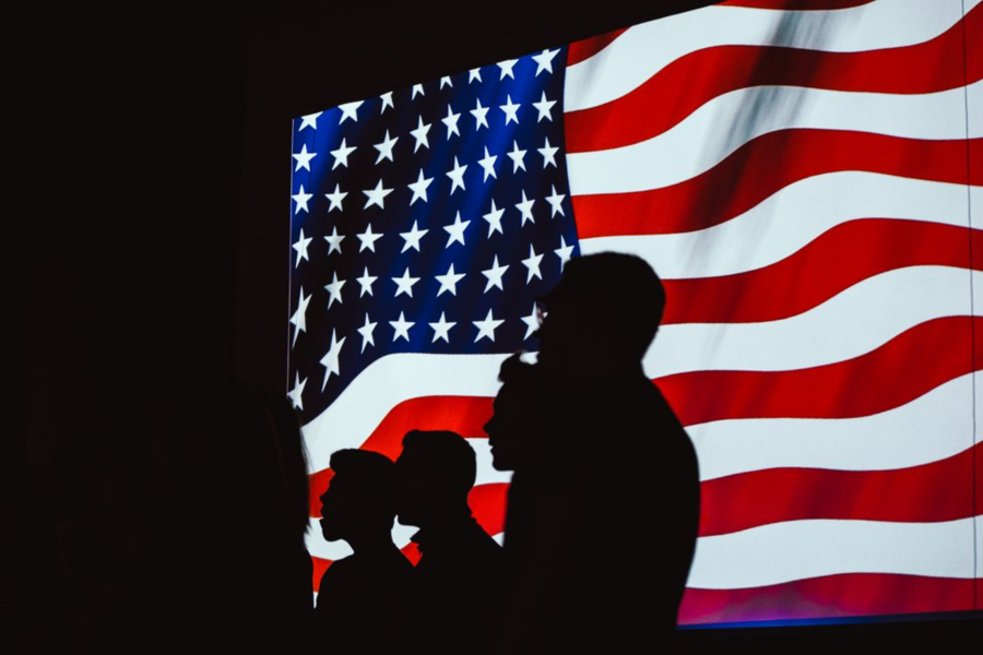 Silhouettes of a family in front of a United States flag representing asylum legal help and immigration protection with J Kelley Law Group