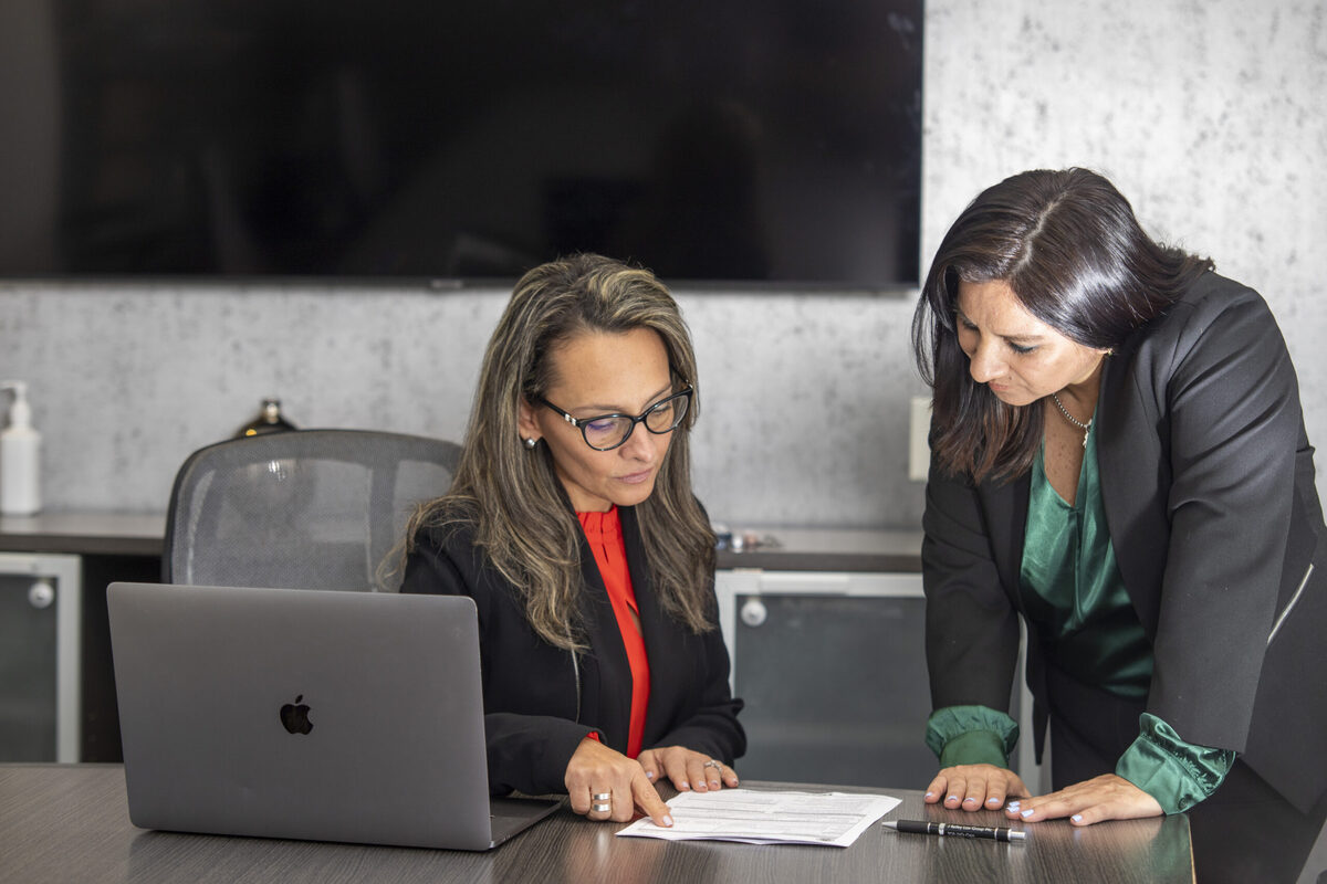 Attorney Johanna Kelley and a case manager reviewing documents in an office, representing family law consultation and legal support for Maryland clients.