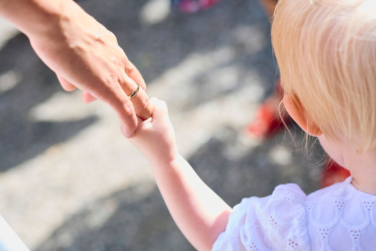 Child holding an adult’s hand, representing stability and child custody modification guidance for Maryland families with J Kelley Law Group