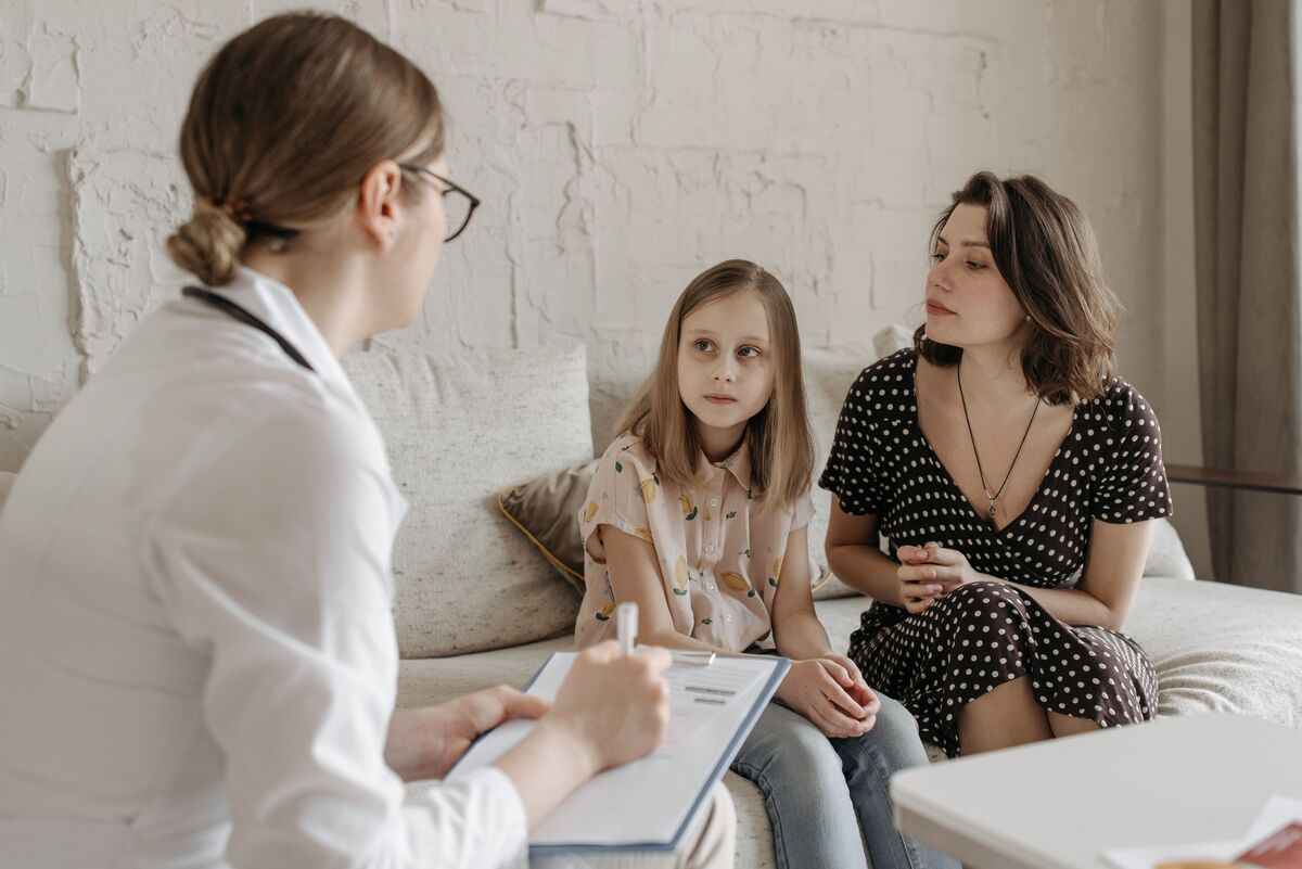 Parent and child in a consultation reviewing documents for a Maryland child support matter